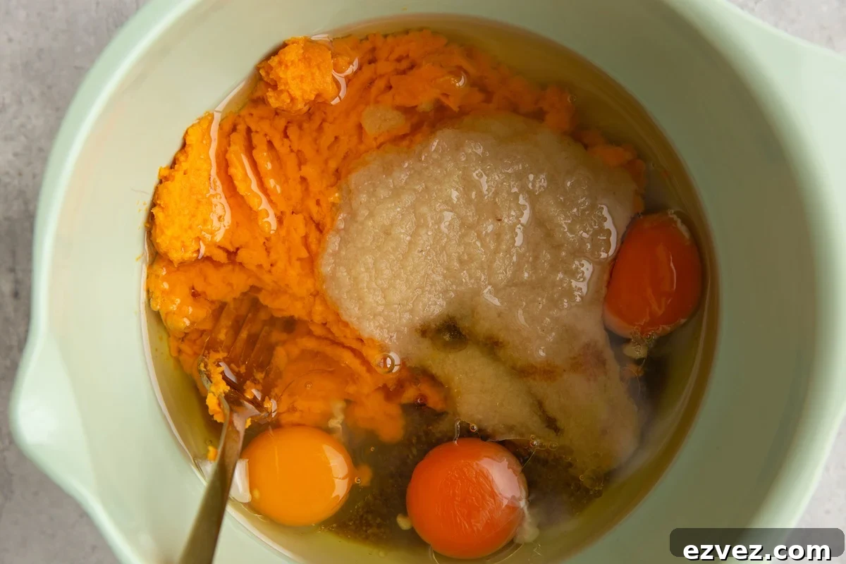 Mixing bowl full of wet ingredients to make sweet potato bread, ready to be mixed together.