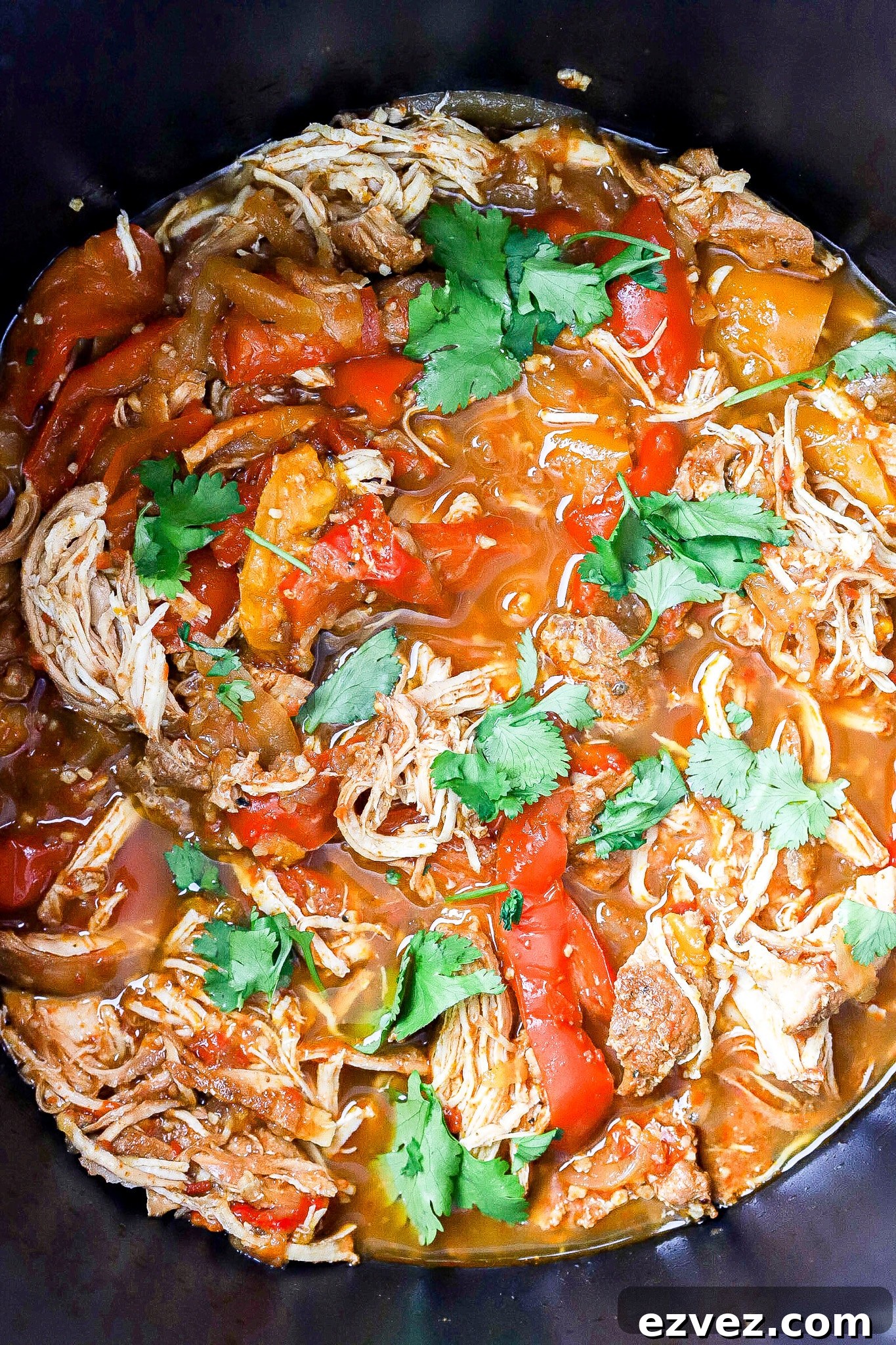 Top down view of slow cooker chicken fajitas with cilantro.