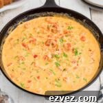 Side view of a skillet full of crawfish sauce.