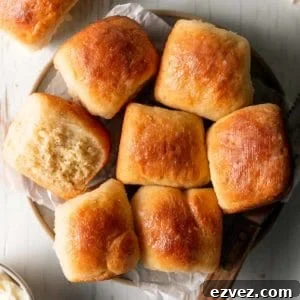 A plate of gluten free Hawaiian rolls, one on it's side to show texture.