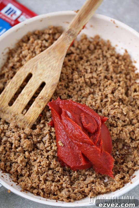 15-Minute One-Pot Sloppy Joes Recipe 3 A skillet of cooked ground beef, with tomato paste being mixed in