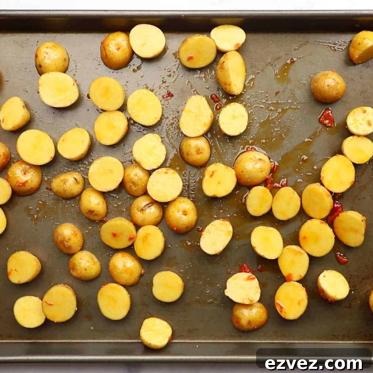 potatoes spread on a baking sheet