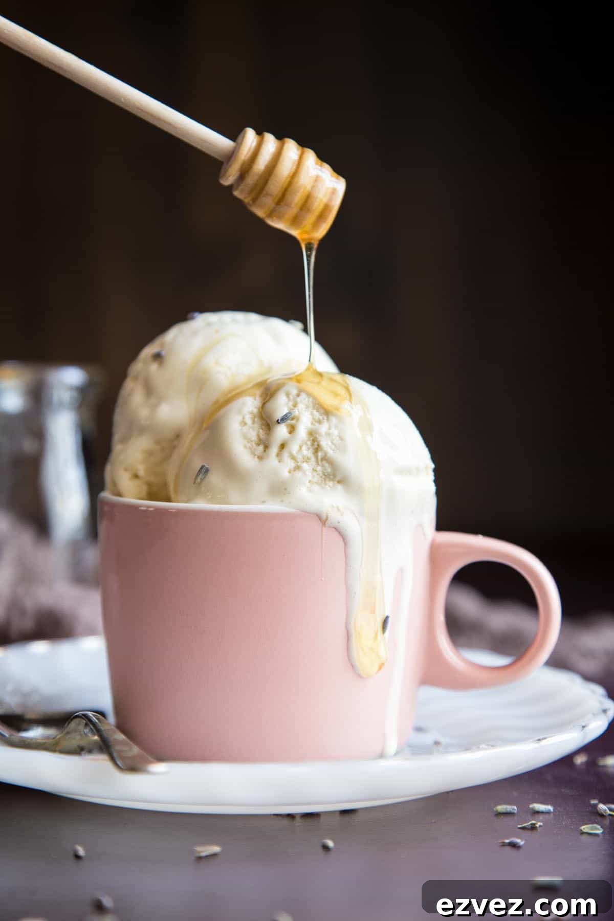 Honey drizzling into a cup of lavender ice cream.