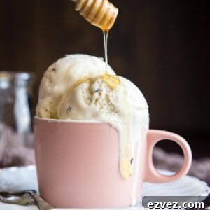 Honey drizzling into a cup of lavender ice cream.