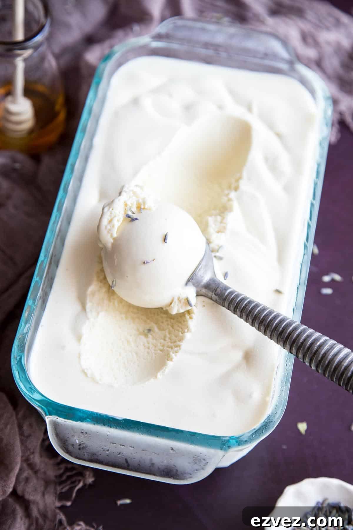 An overhead image showing honey lavender ice cream in a glass container.