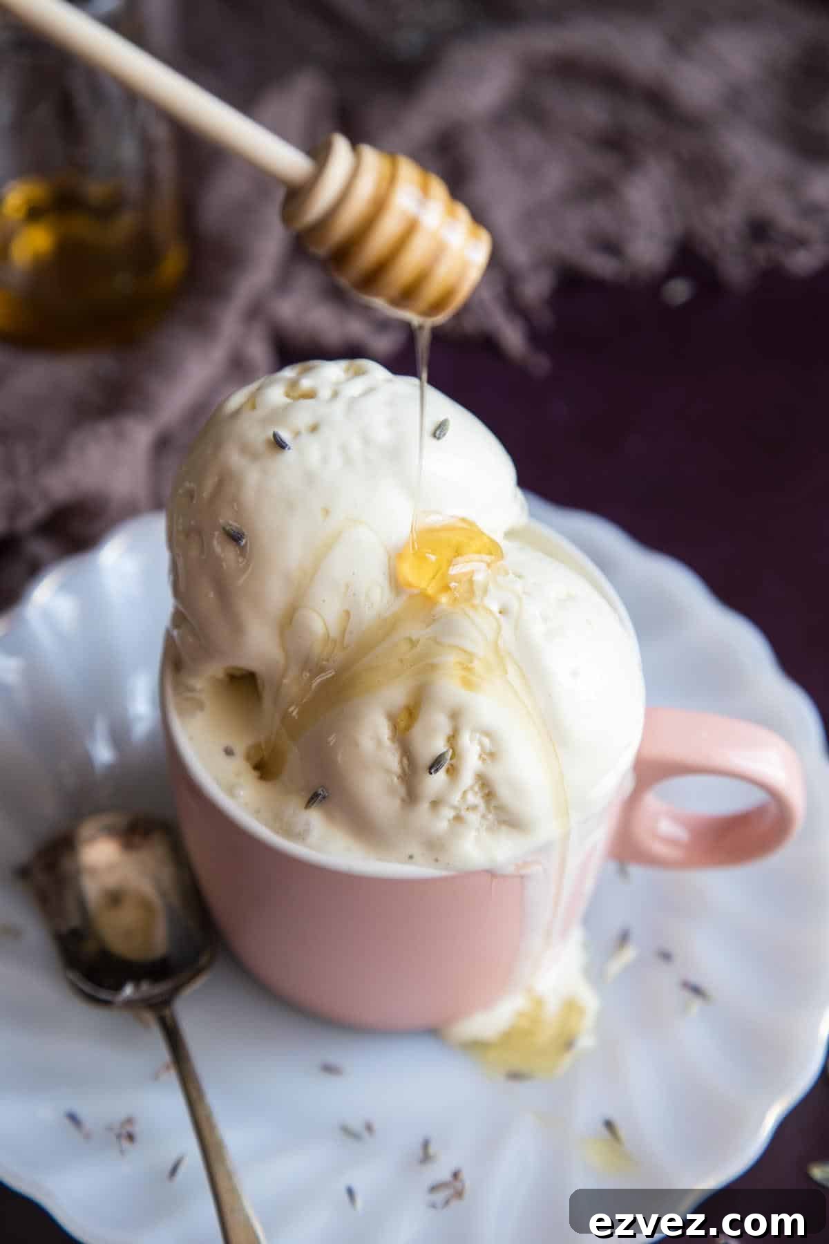 Honey drizzling into a cup of lavender ice cream.