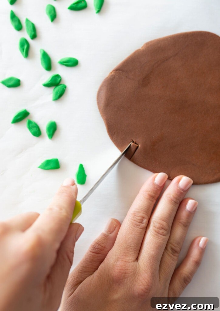 cutting green fondant into leaves
