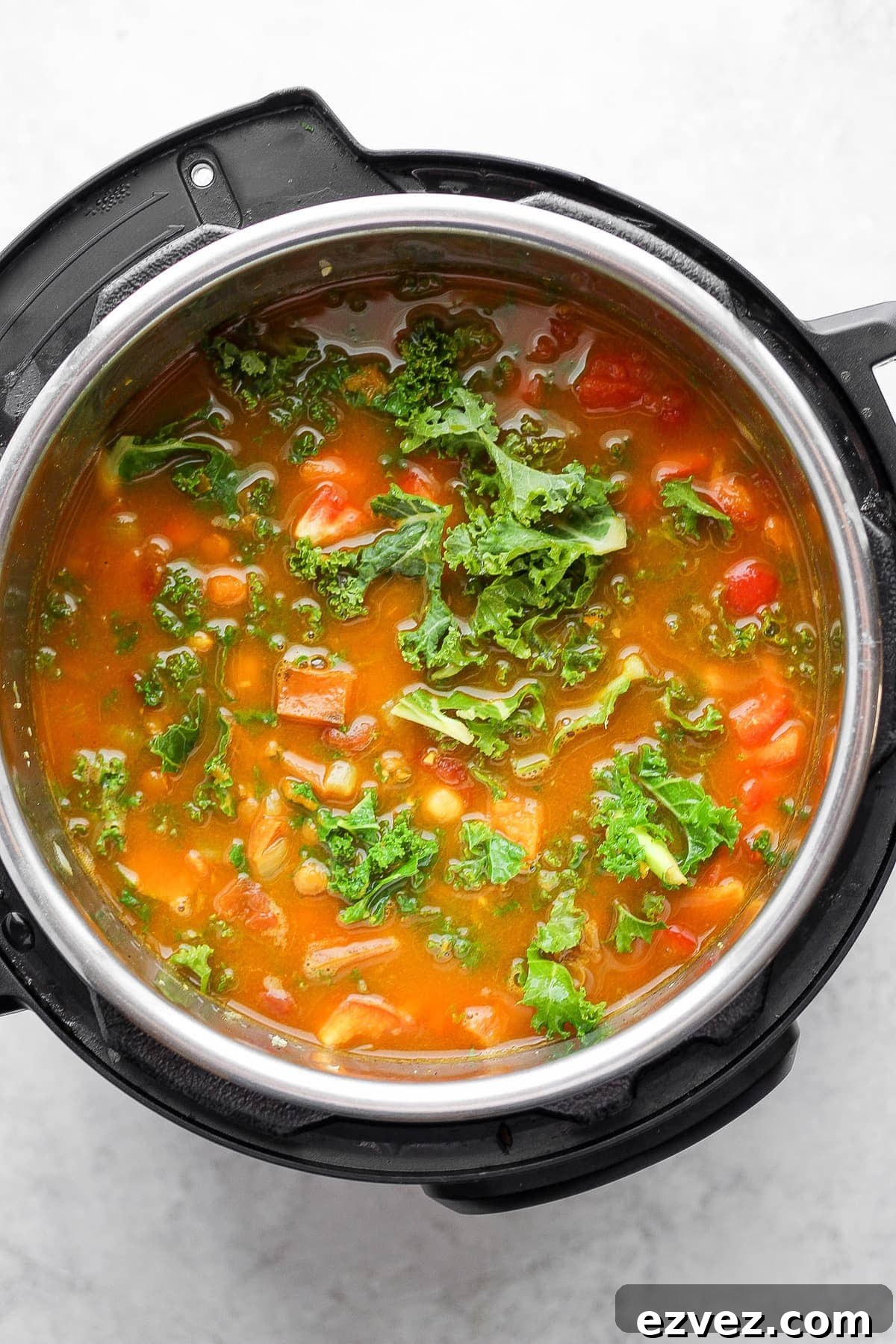 Instant Pot lentil soup with fresh kale on top. 
