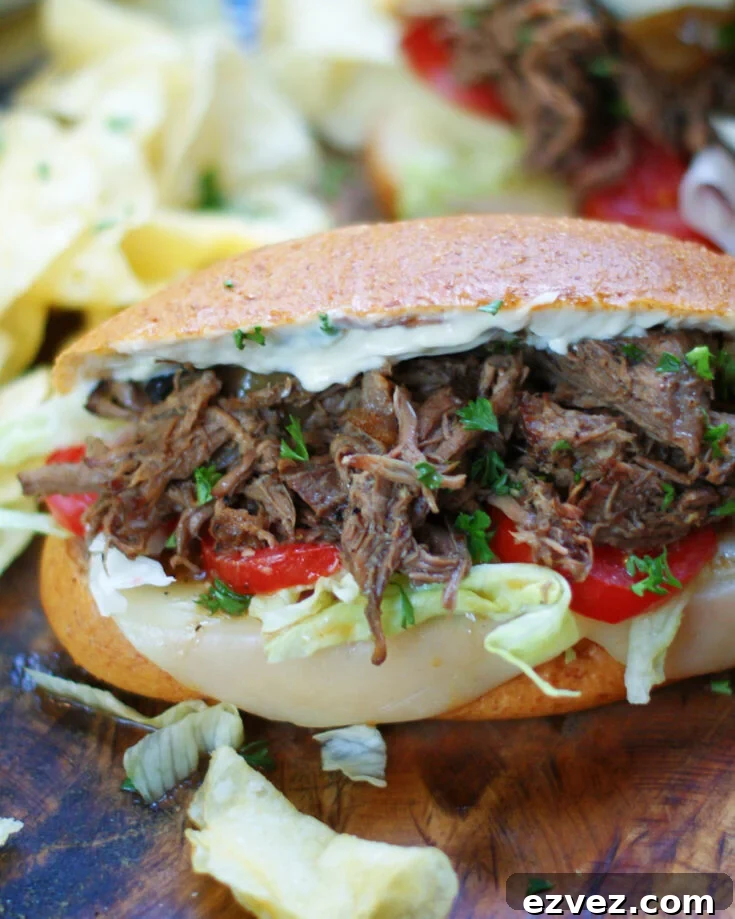 A hot Louisiana Roast Beef Po Boy Sandwich dressed with horseradish, lettuce, tomatoes and Provolone.