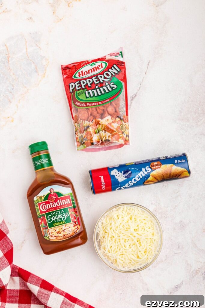 Ingredients needed to make pizza cupcakes on a marble table. 