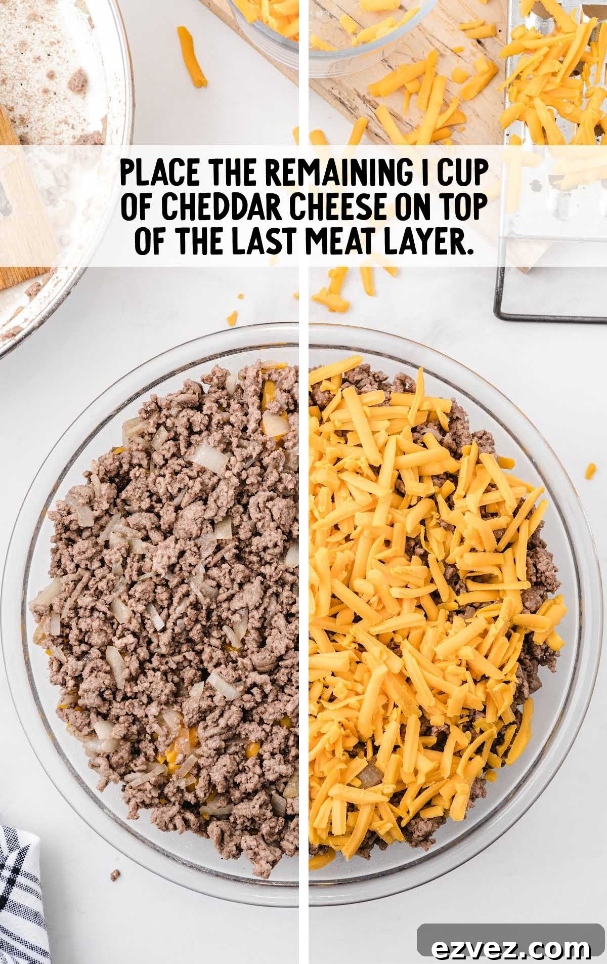 cheddar cheese placed on top of the meat layer in a baking dish