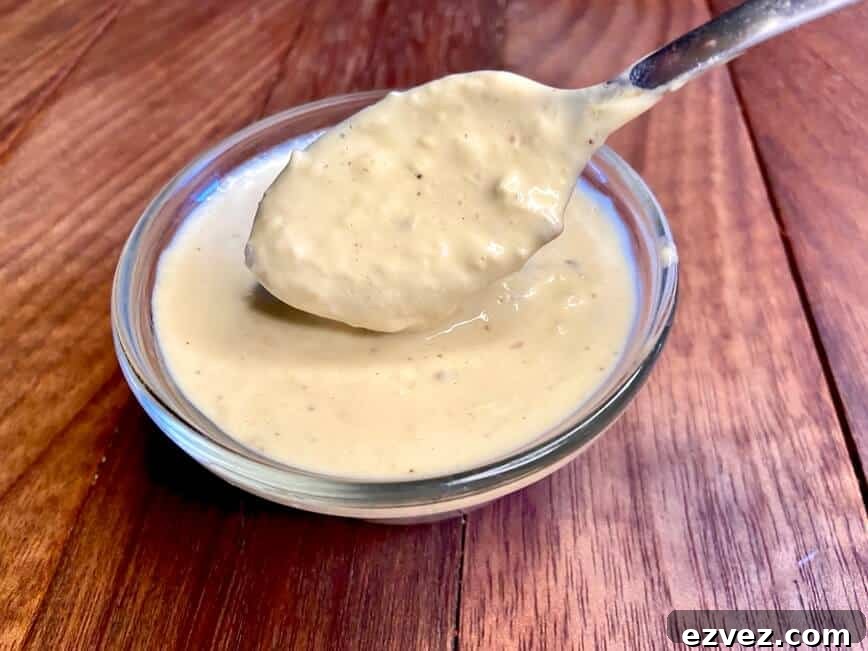 Classic Creamy Caesar Dressing Recipe 6 Dressing on a spoon.