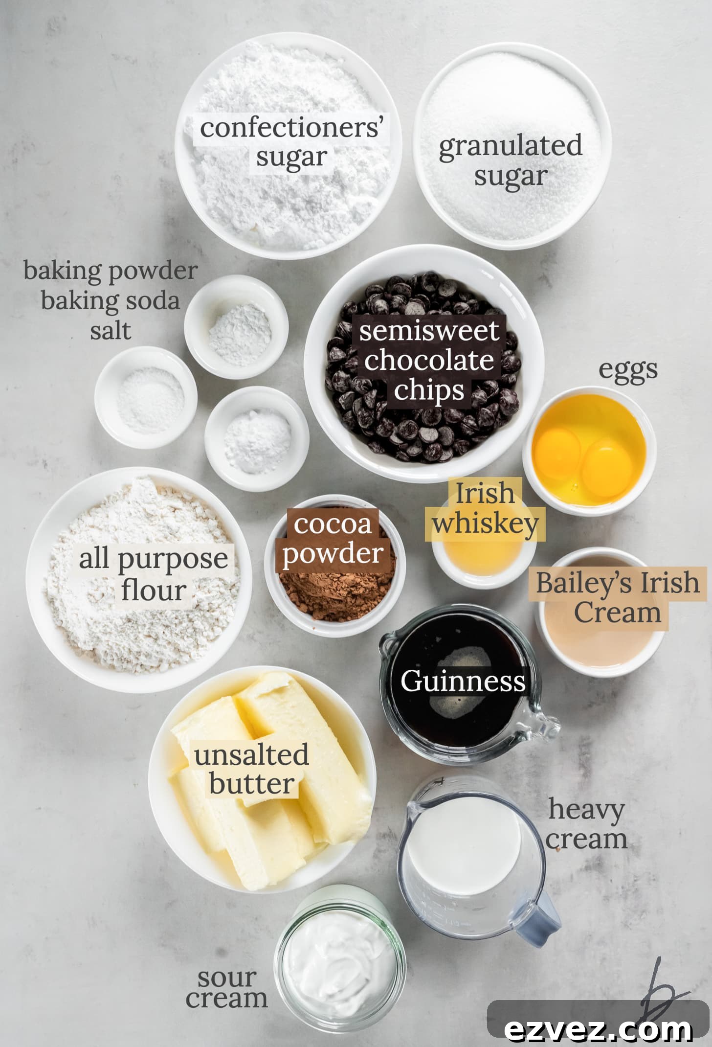 guinness cupcakes and baileys frosting ingredients in bowls labeled with text.