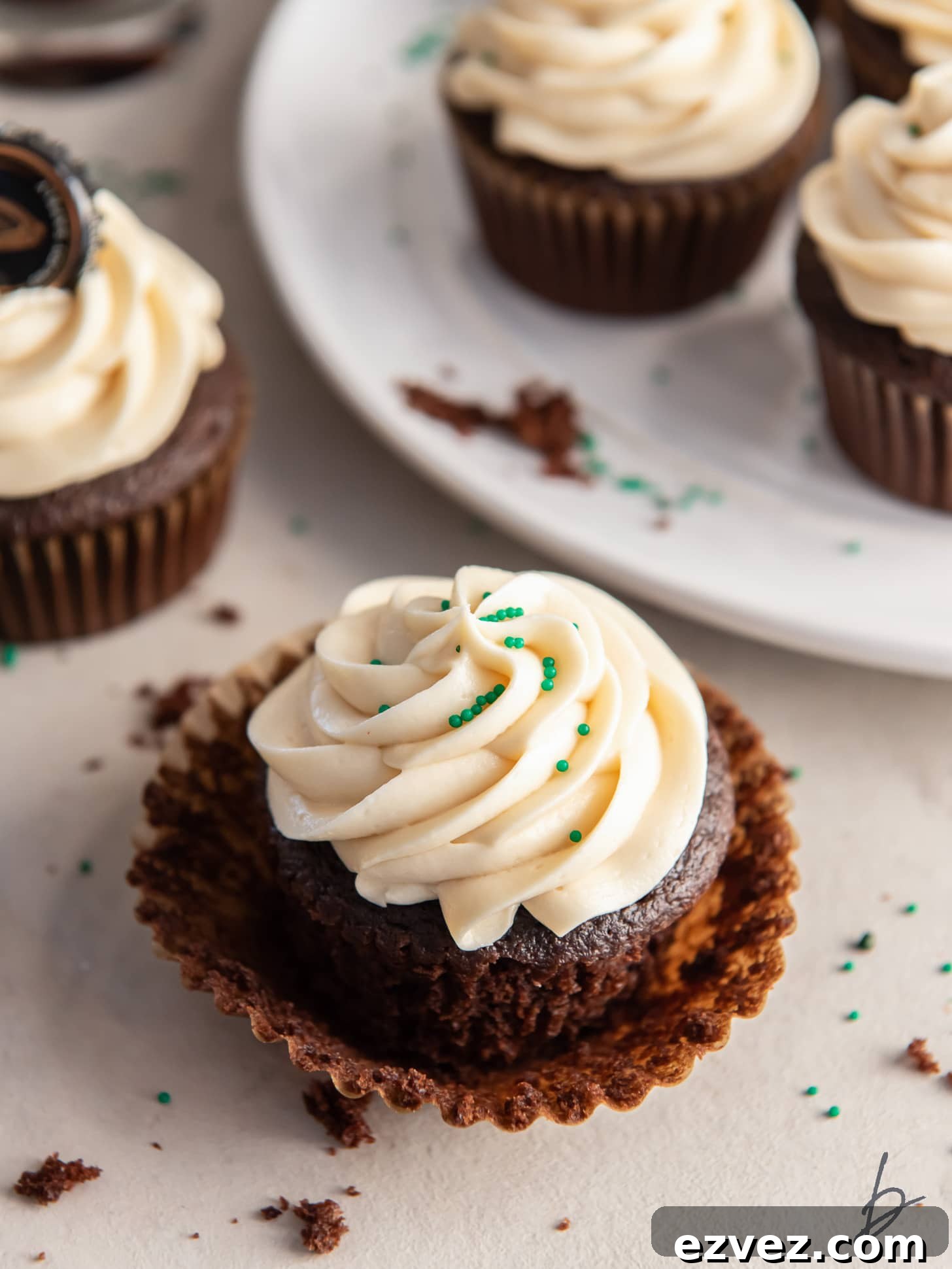 chocolate stout cupcake with irish cream frosting on paper cupcake liner.