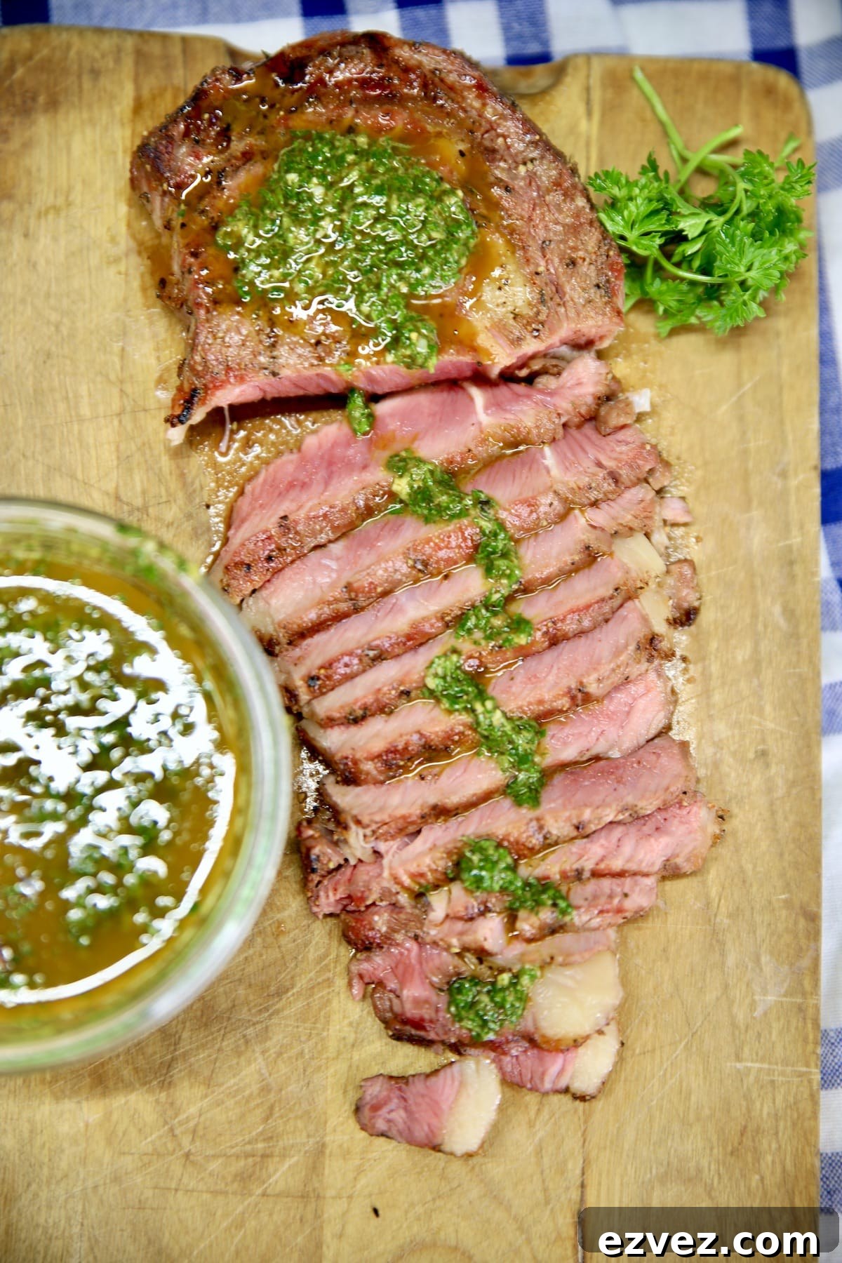 Chimichurri Steak on a cutting board, partially sliced.