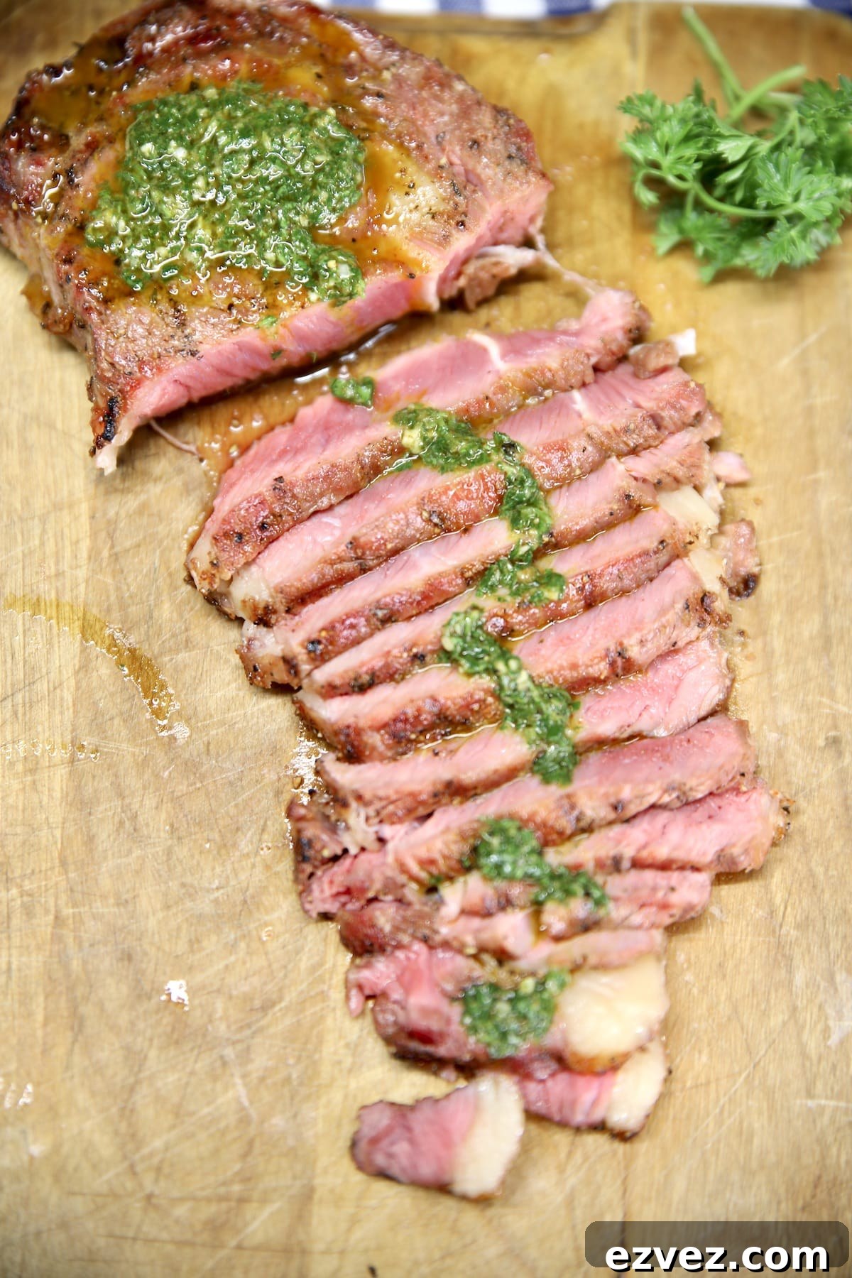 Sliced steak with chimichurri sauce.