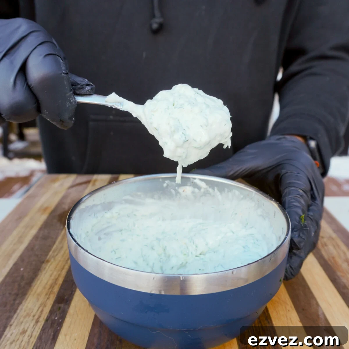 Authentic Grilled Chicken Shawarma Recipe for Flavorful Meals 6 homemade tzatziki sauce in a spoon over a blue yeti serving bowl.