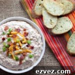 Overhead picture of a bowl of dip with toasted baguettes