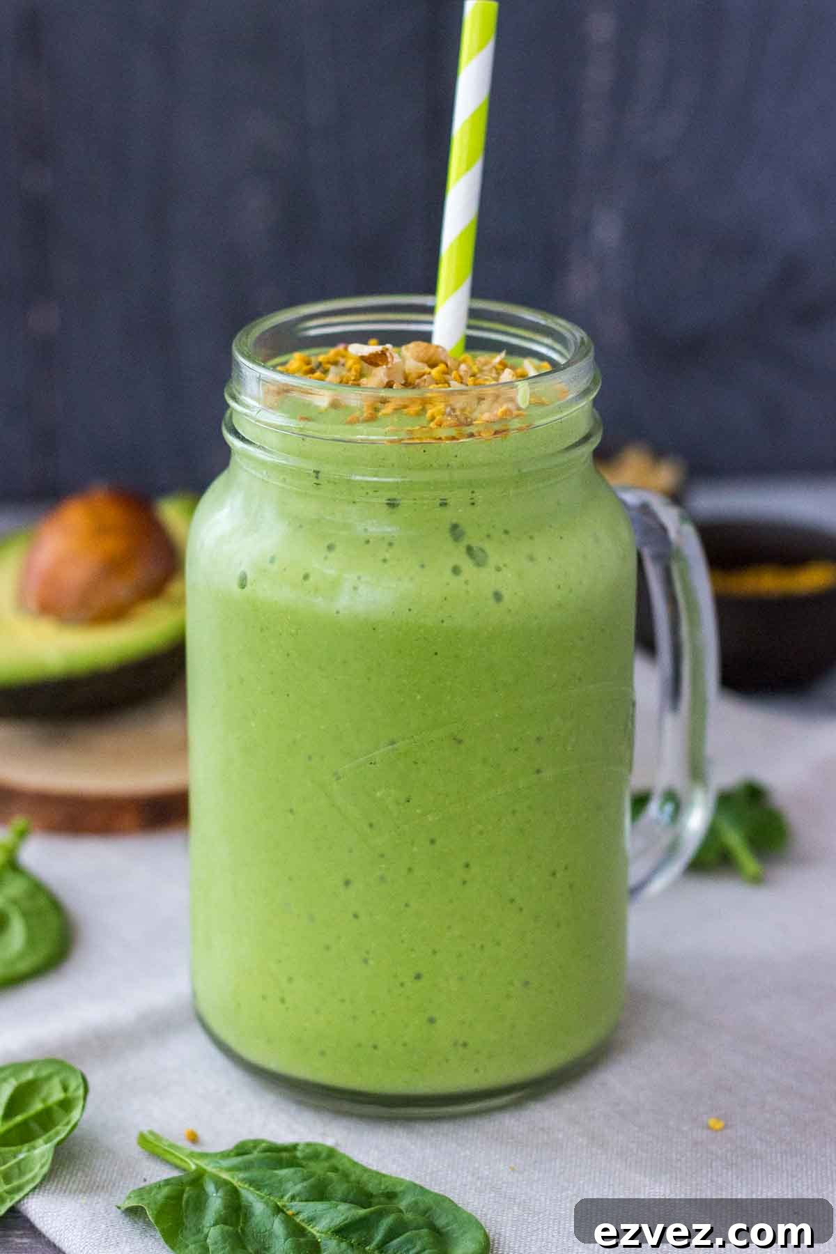 Avocado Smoothie in a glass with a straw