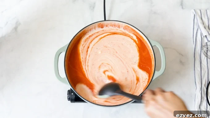 A pot of tomato soup with heavy cream