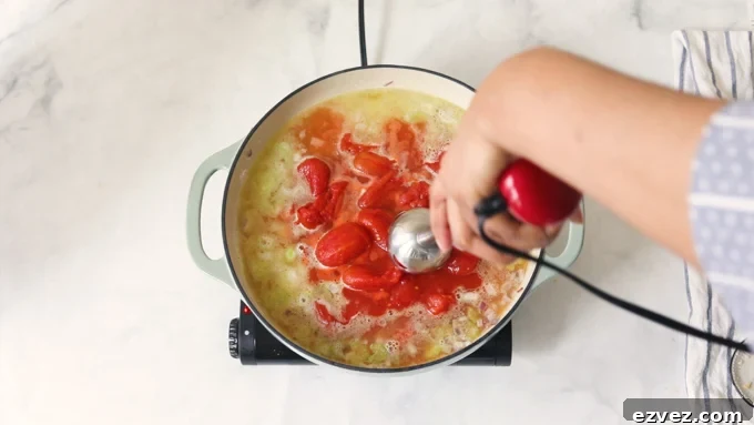 Using an immersion blender to puree the soup