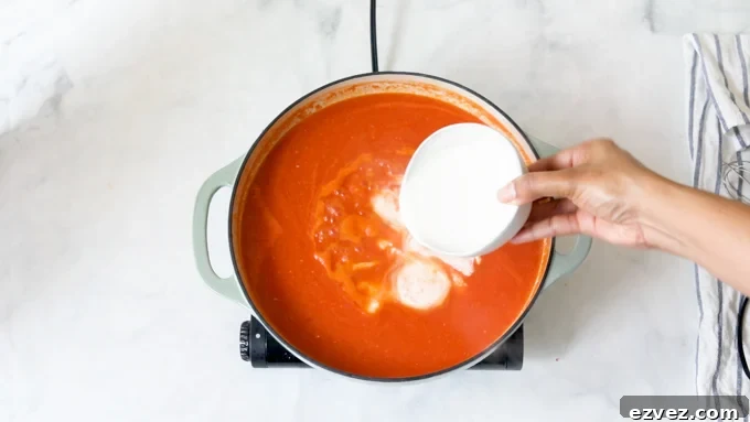 Pouring milk into the soup