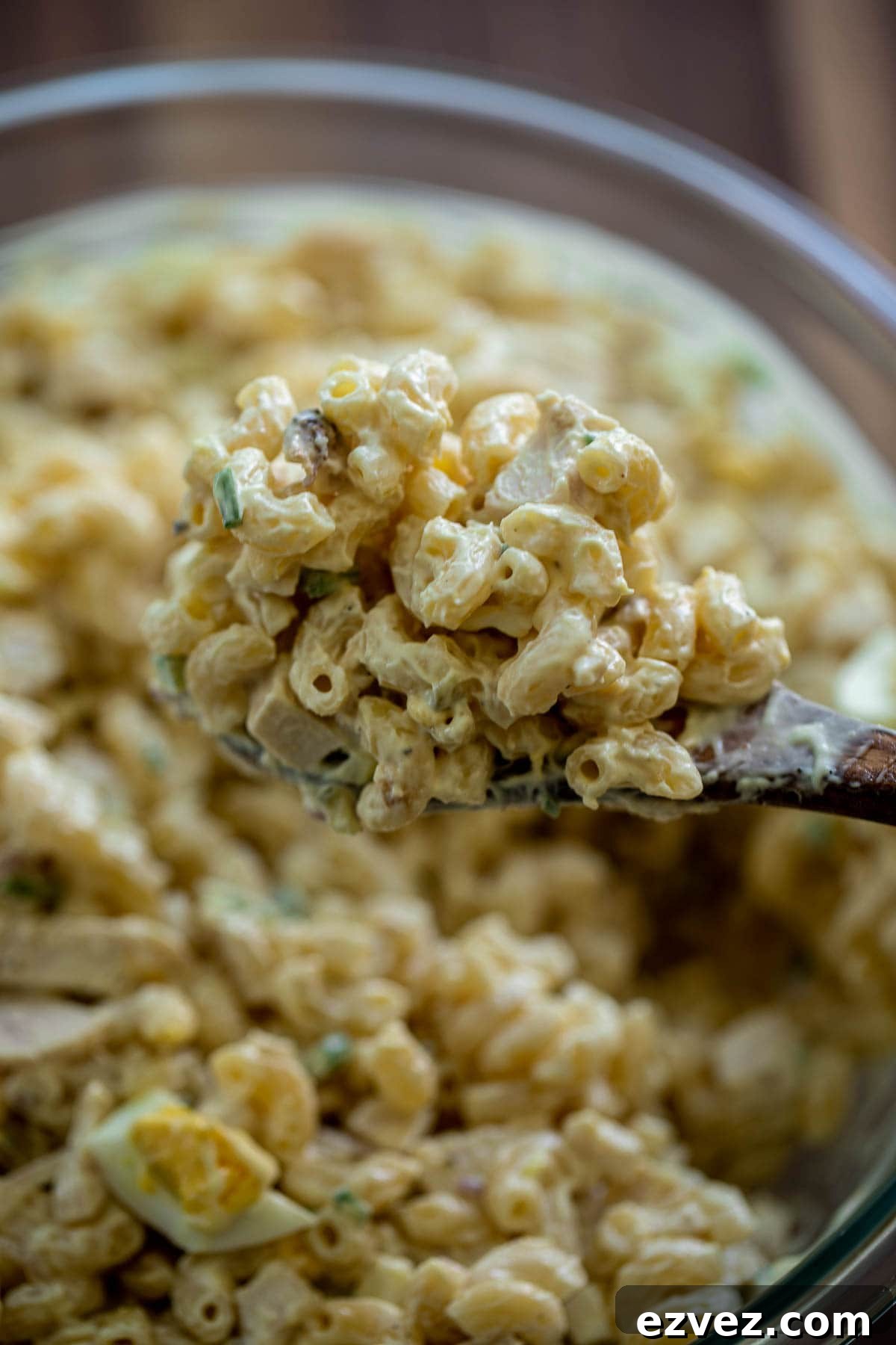Creamy Chicken Macaroni Salad with Tangy Herb Dressing 3 Wooden spoon lifted up of macaroni salad