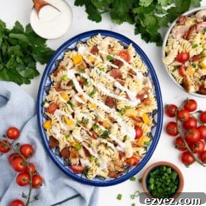 An oval platter of chicken bacon ranch pasta salad on a table.