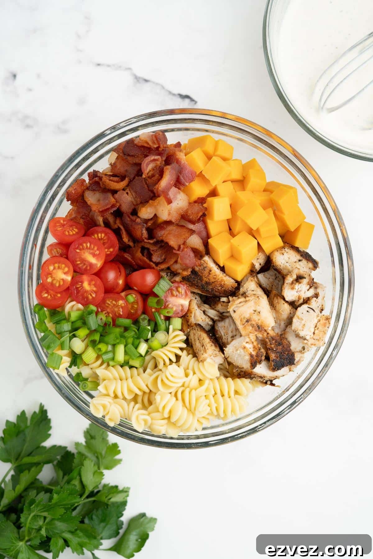 Pasta salad ingredients assembled in a bowl.