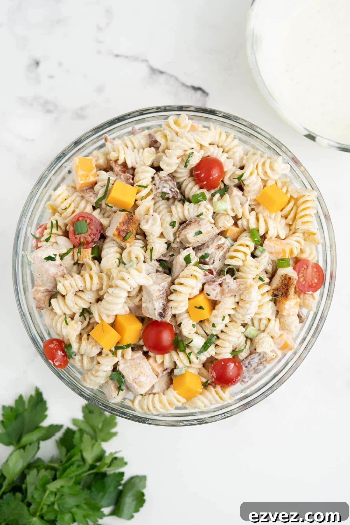Chicken bacon ranch pasta salad mixed in a glass mixing bowl.