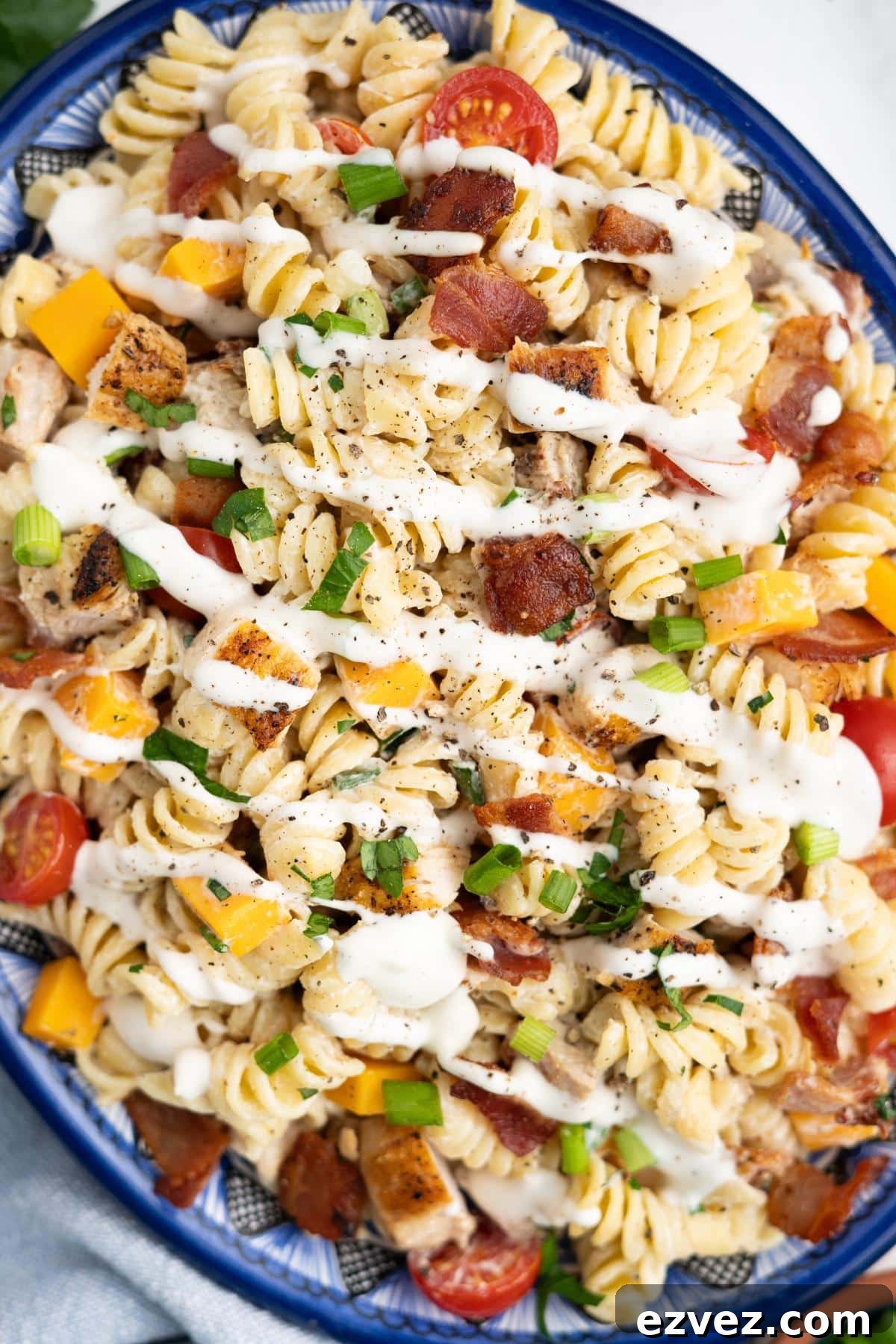Chicken bacon ranch pasta salad on a blue rimmed platter.