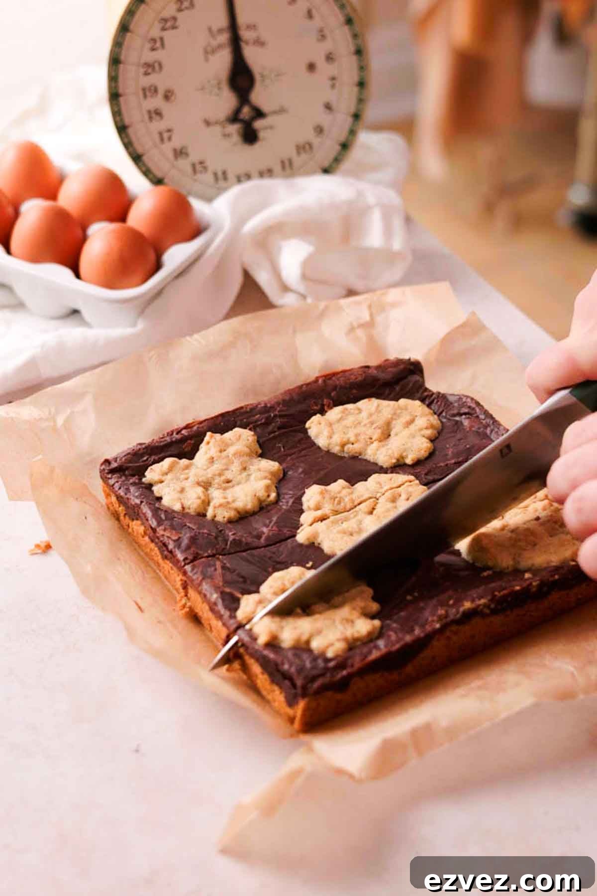 slicing baked oatmeal fudge bars in rectangles with knife