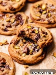 bitten pistachio chocolate cookie on top of whole cookie