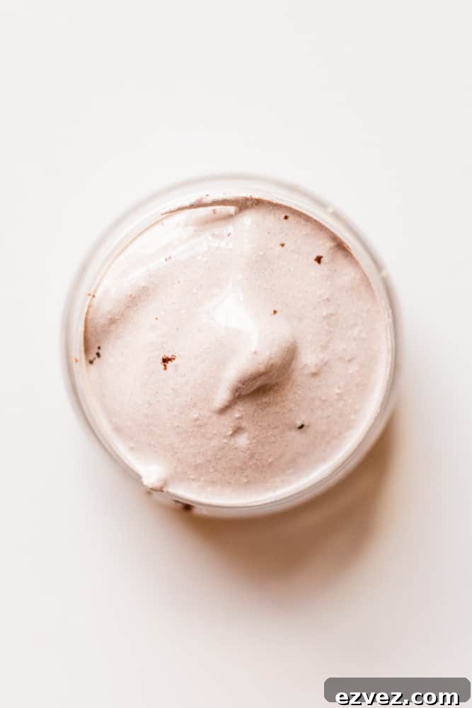 Natural concealer for lighter skin tones on white top.