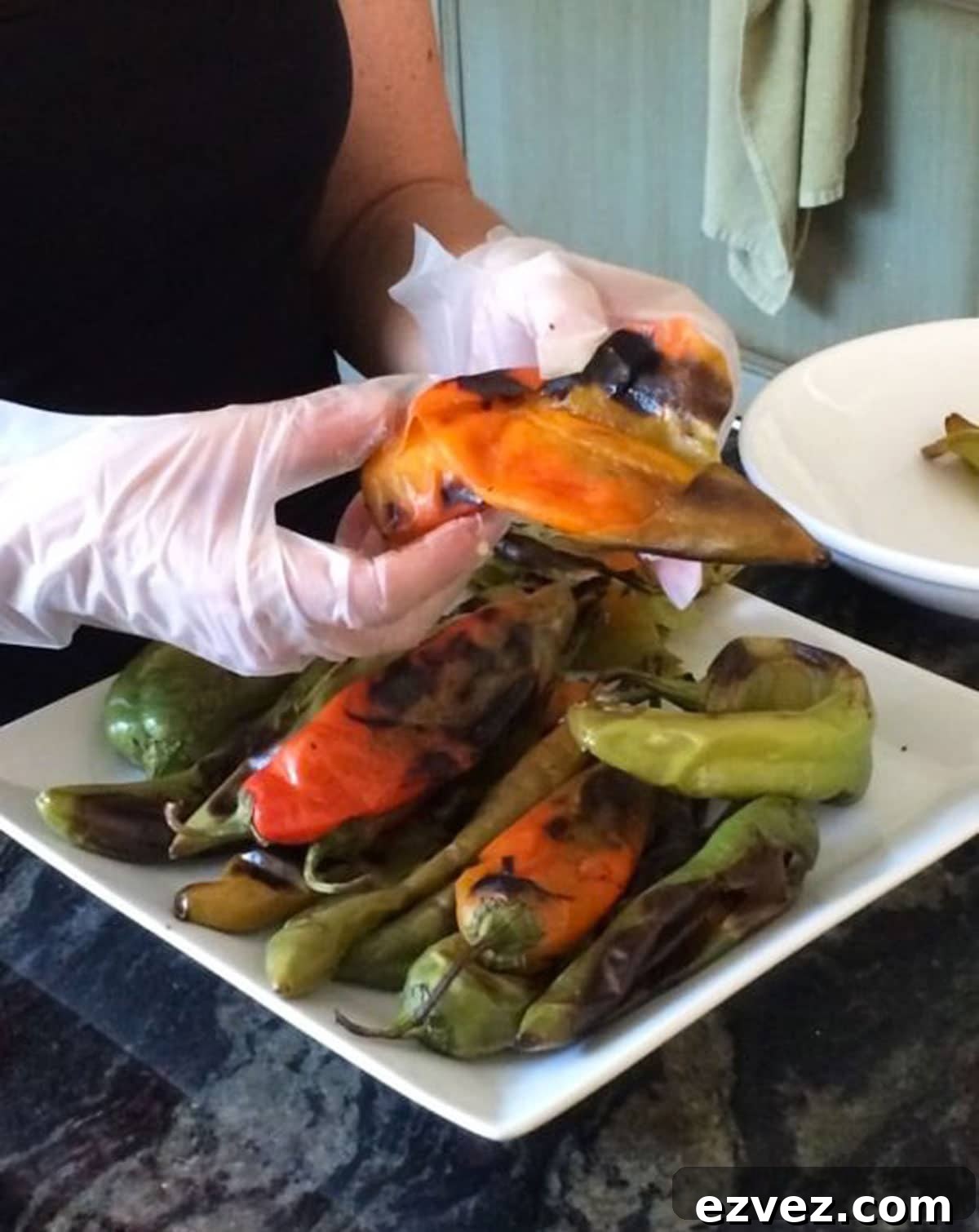 Fire-Roasting Hatch Chiles: Step-by-Step Guide + 12 Delicious Recipes 5 Peeling blistered hatch green chiles.