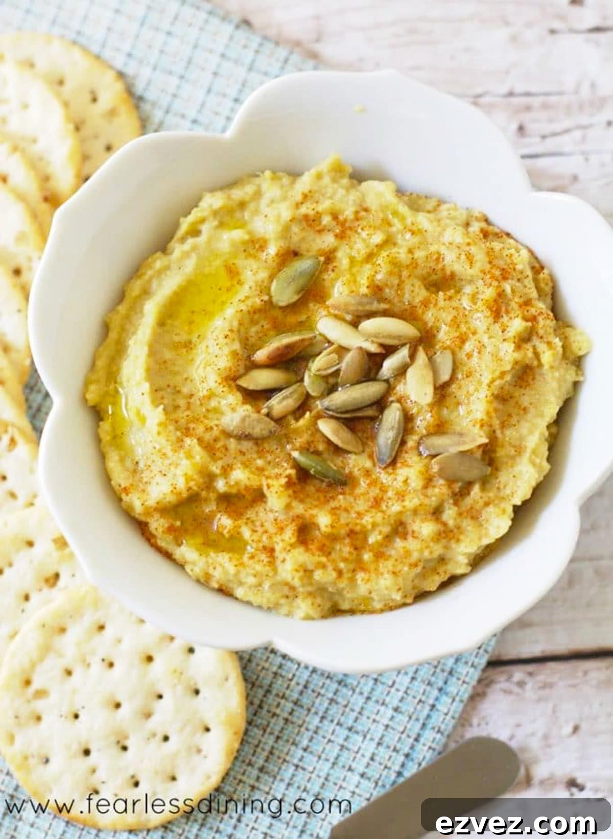 Fire-Roasting Hatch Chiles: Step-by-Step Guide + 12 Delicious Recipes 8 A bowl of hatch chile spicy hummus next to crackers.