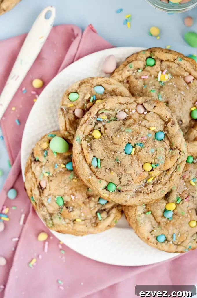 Light golden brown mini egg chocolate chip cookies full of fun pastel colored sprinkles.