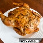 The finished Basic Herb-Roasted Chicken resting on a white plate