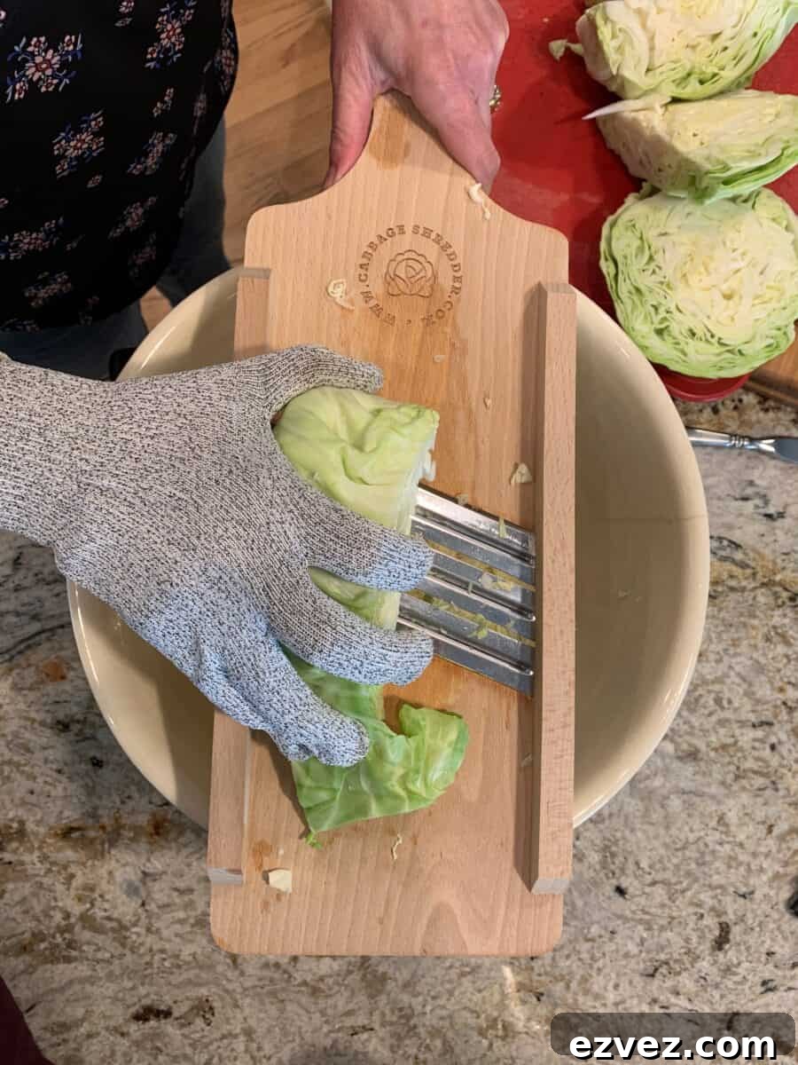A protective glove worn, shows how to safely use a mandolin shredder.