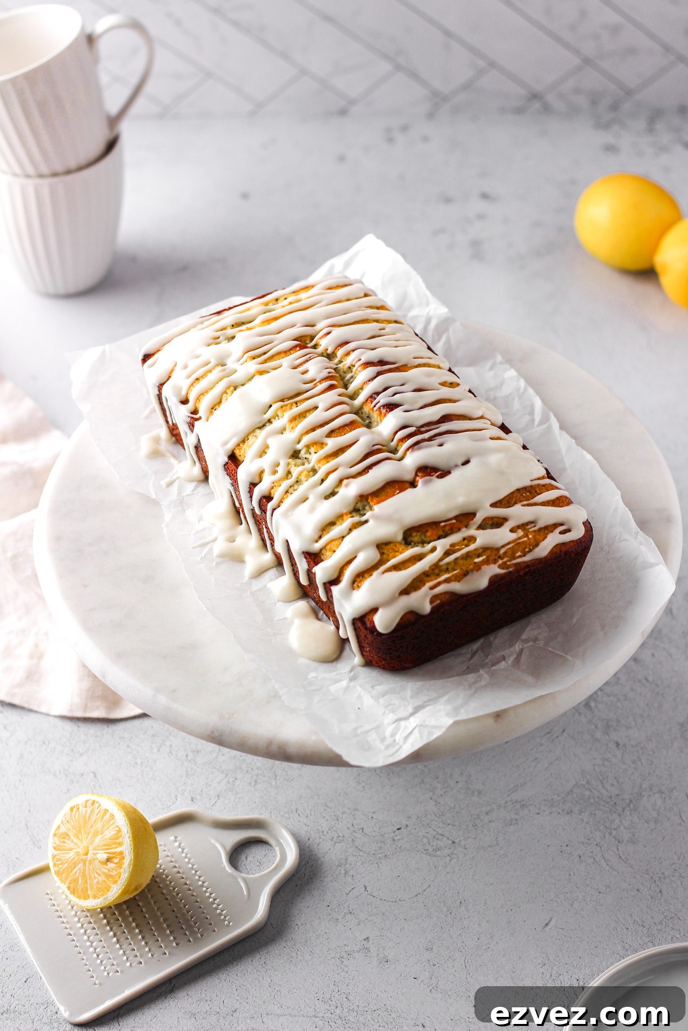 lemon loaf with white glaze and lemons for a baking blog recipe and food photography
