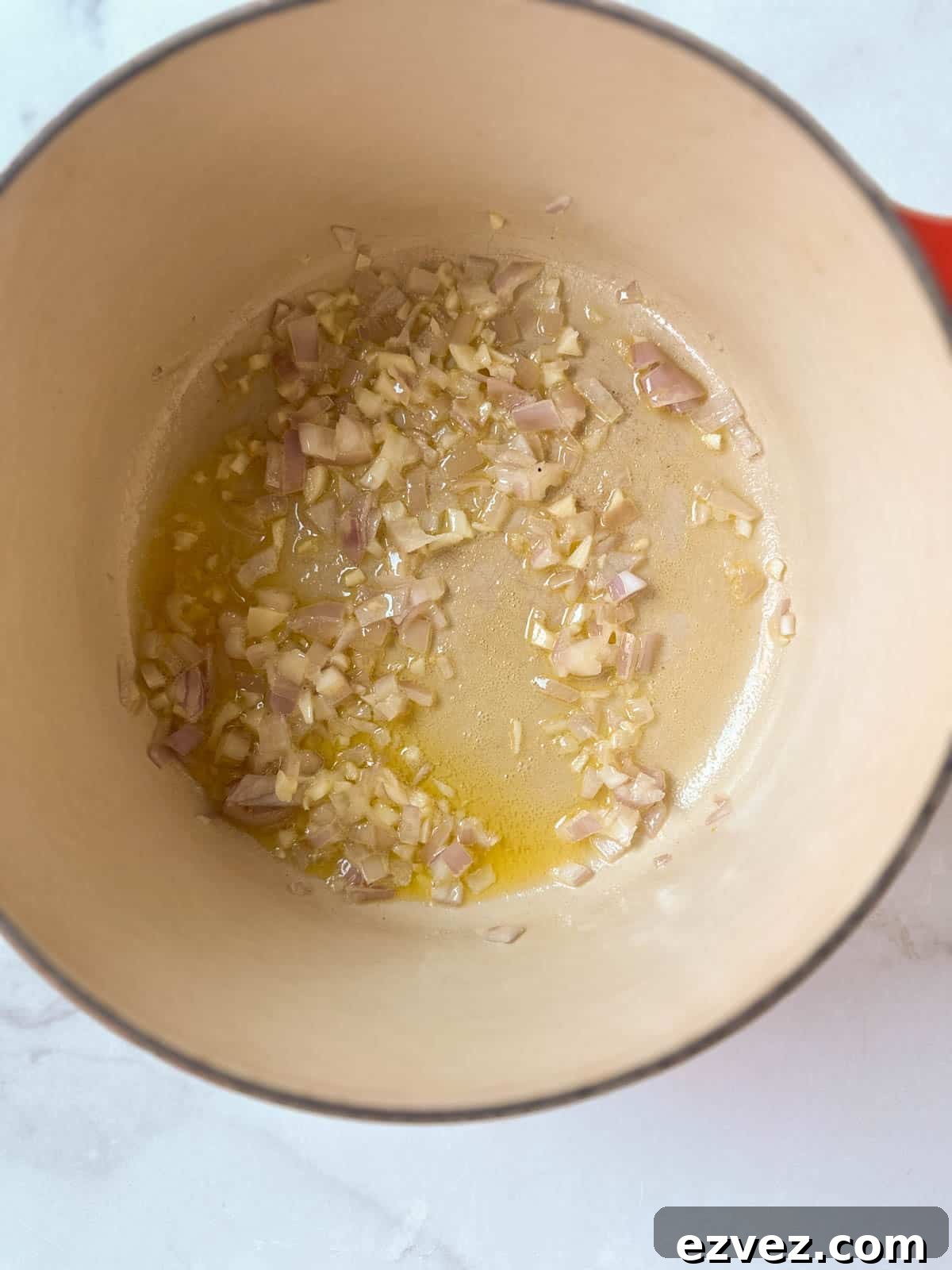 Shallots and garlic in a dutch oven with melted butter.