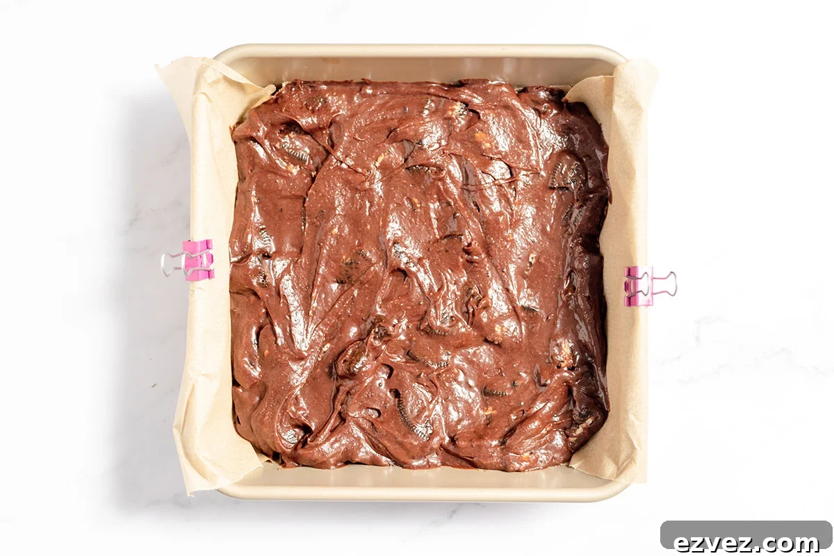 Cookies & Cream Brownies Recipe — Fudgy Oreo-Stuffed Brownies 9 Cookies and cream brownie batter in the baking pan.