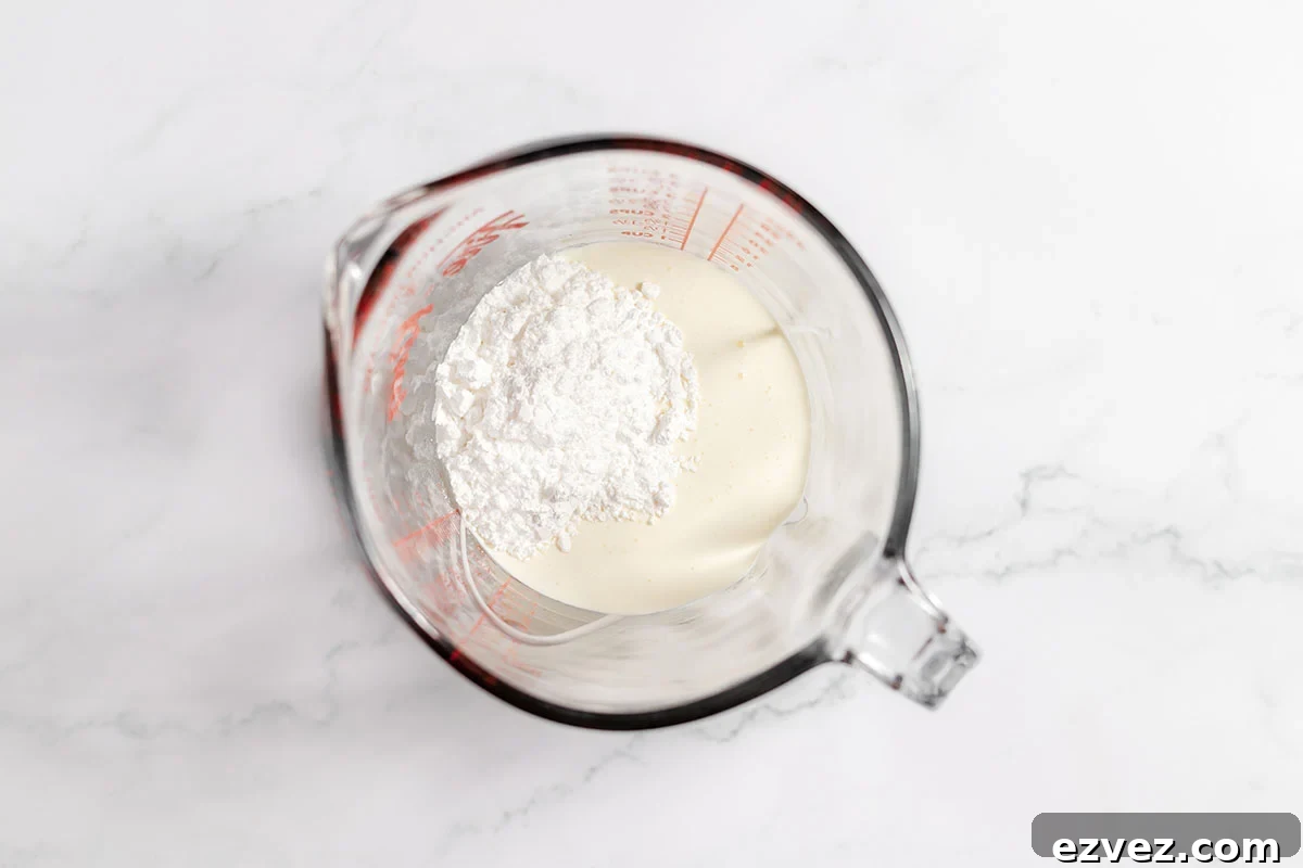 Cookies & Cream Brownies Recipe — Fudgy Oreo-Stuffed Brownies 10 Heavy whipping cream and powdered sugar in a mixing bowl.