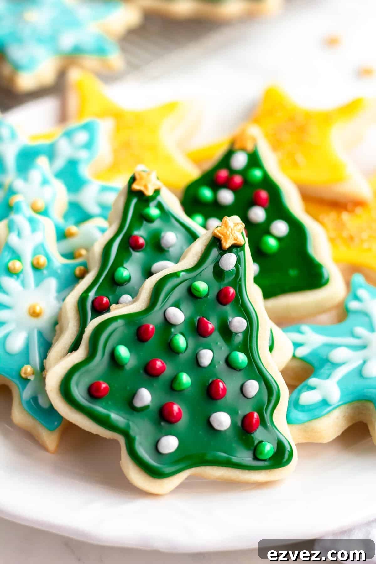 christmas cookies on a plate, showing trees, stars and snowflakes
