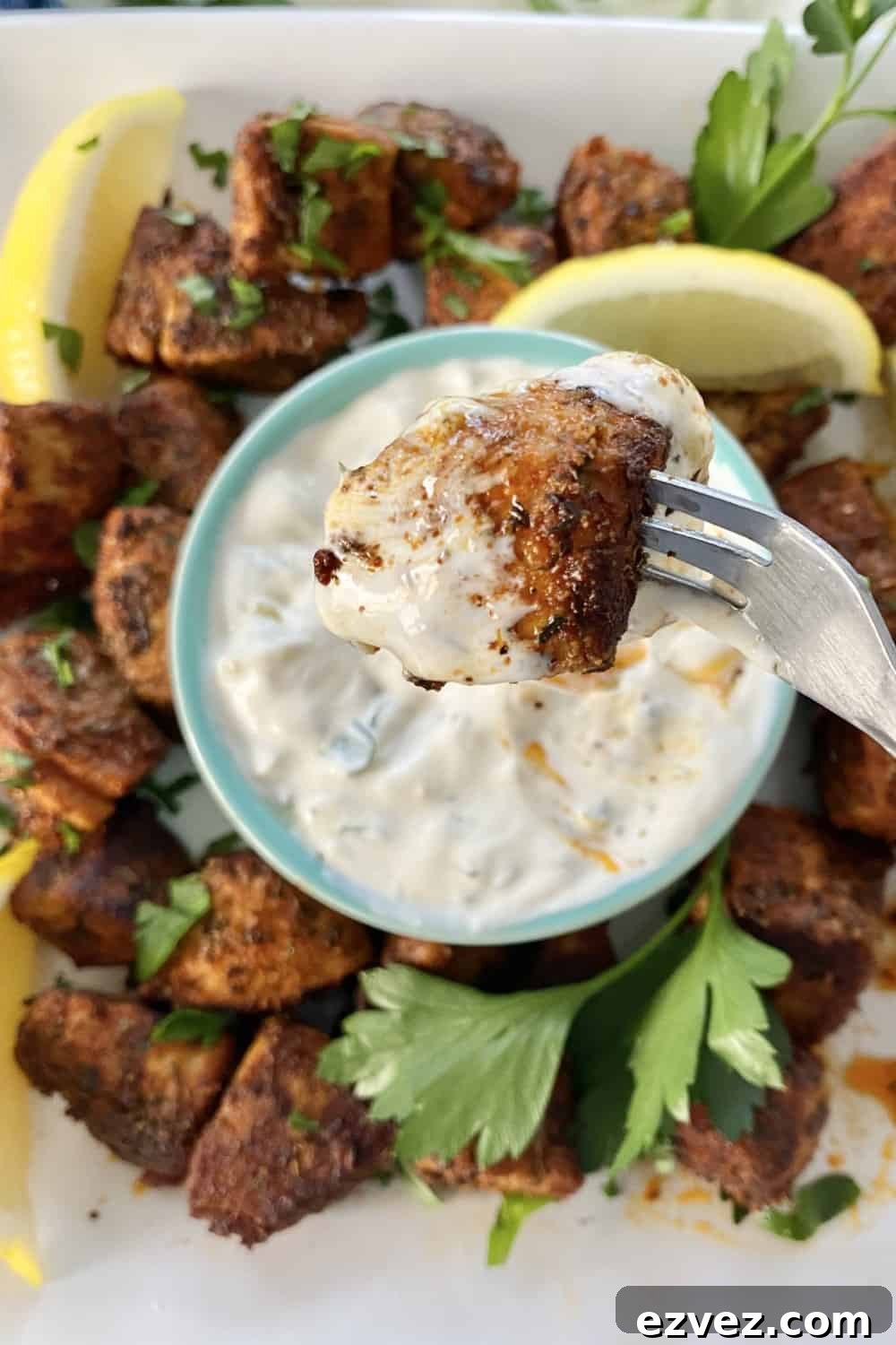 blackened tuna bite dipped in sauce
