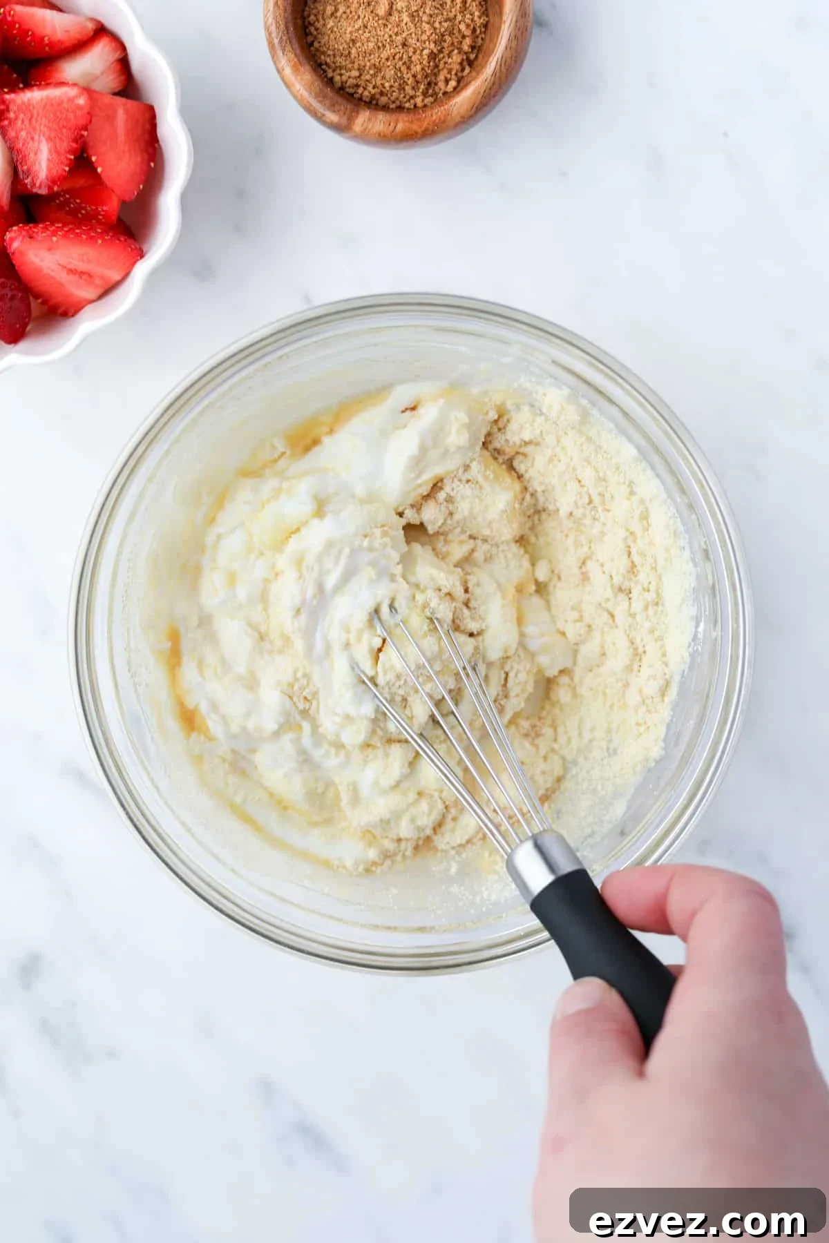 Whisking together a bowl of yogurt with other ingredients.