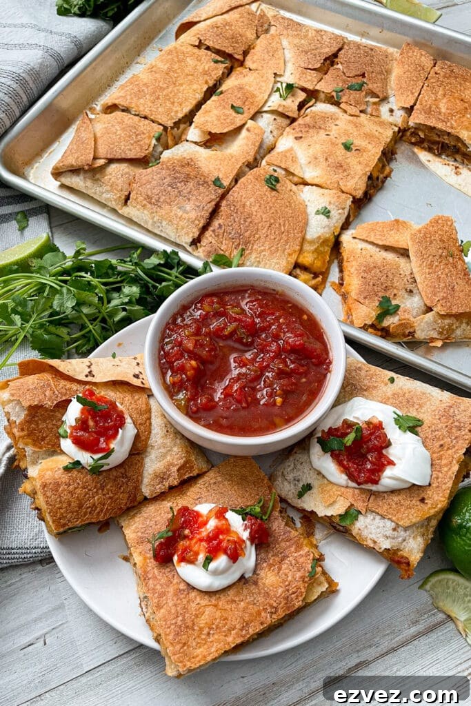 Sheet pan quesadillas served with salsa and sour cream