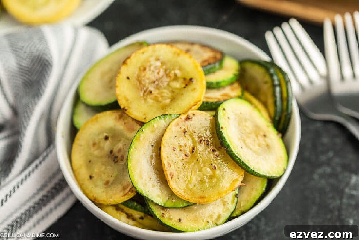 Cooked Zucchini and Squash in a white bowl.