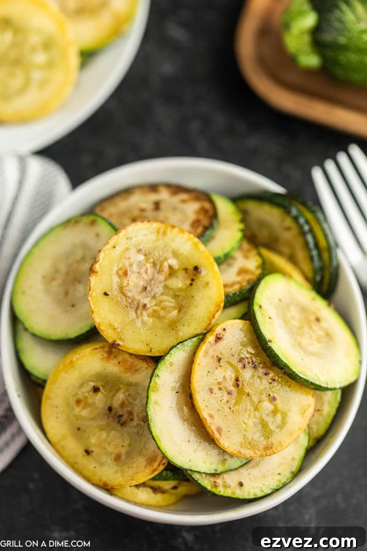 Cooked Zucchini and Squash in a white bowl.