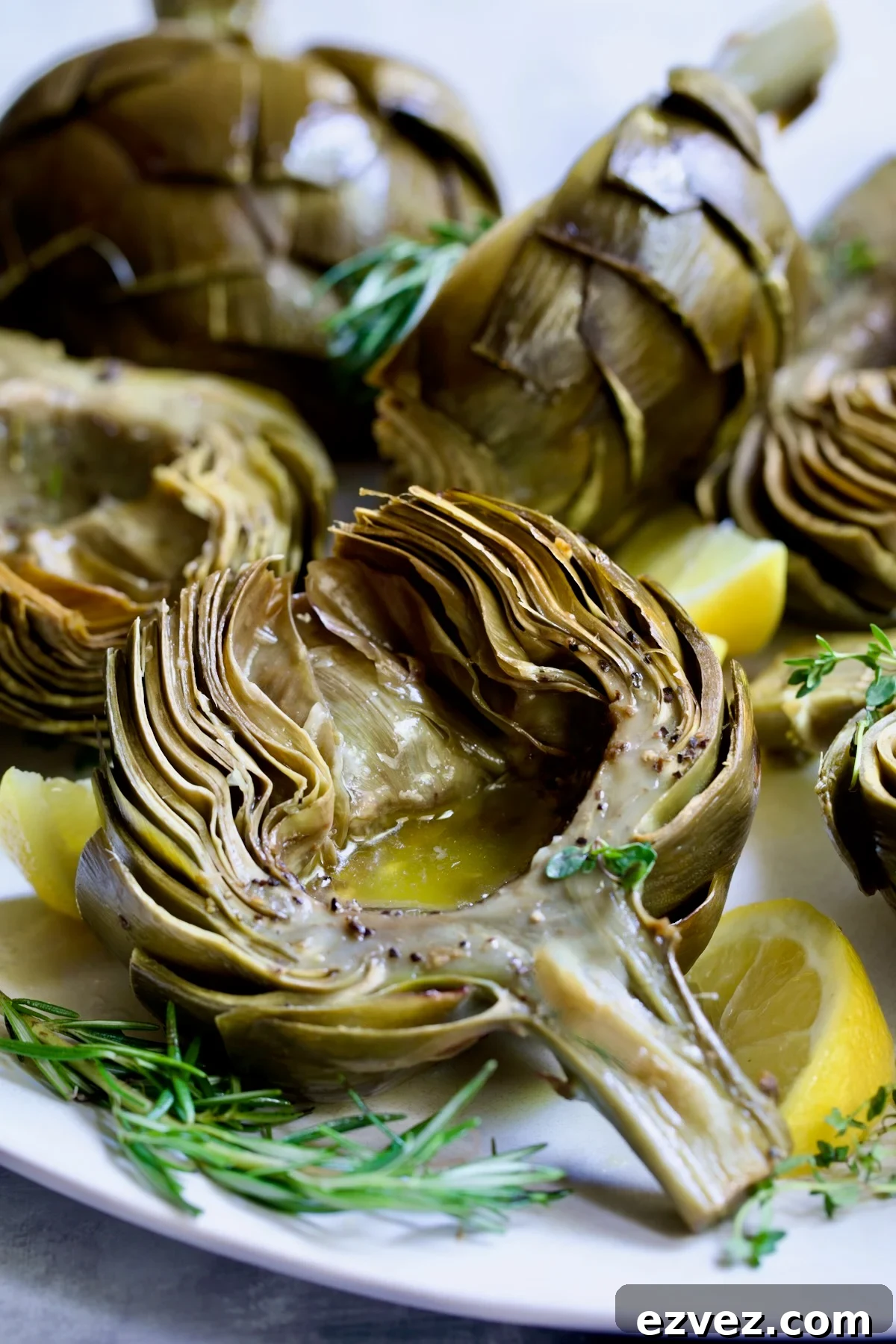 Roasted Artichoke with Garlic Butter in the well of the artichoke.